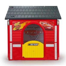 Cars garage playhouse with red walls, gray roof, and yellow front door