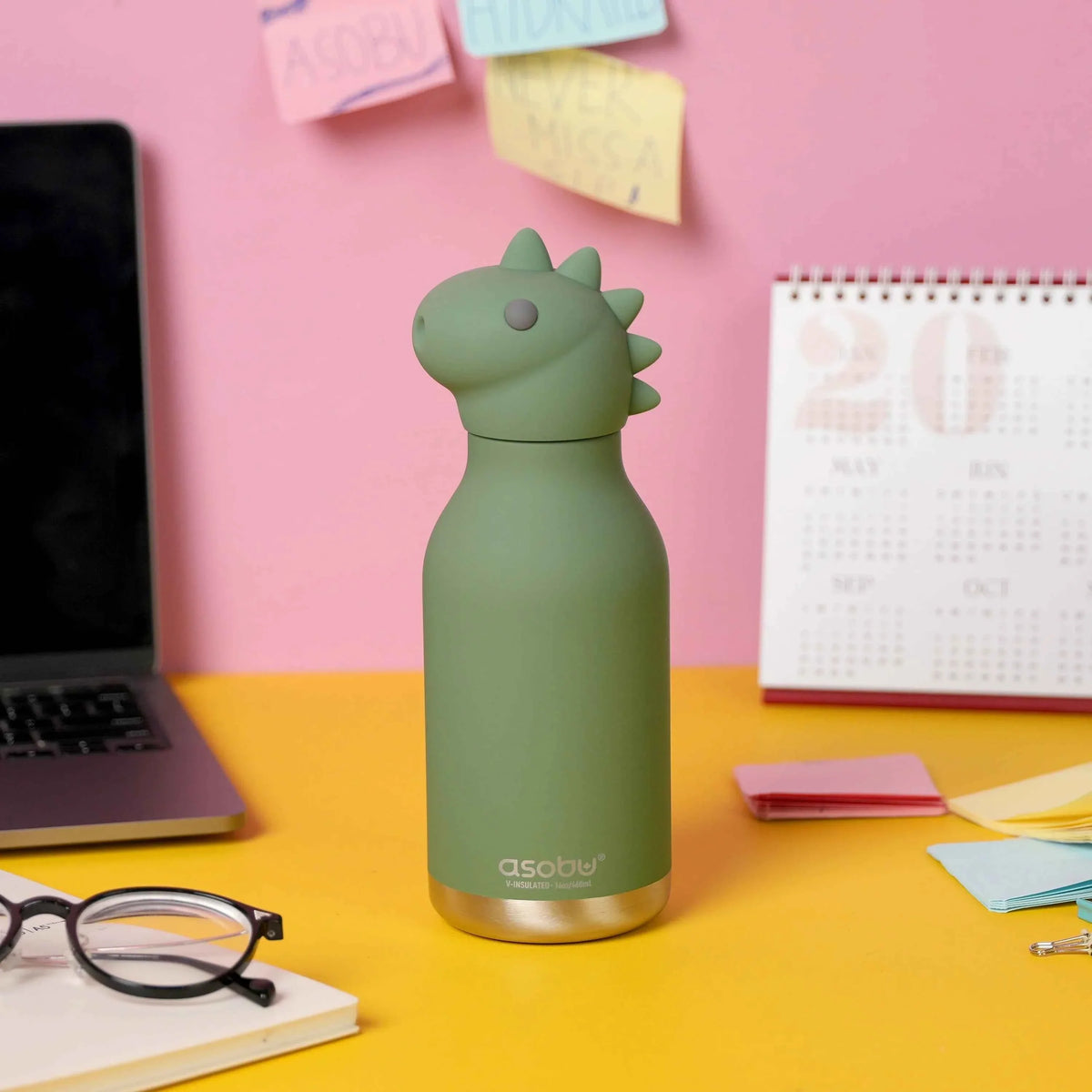 Dinosaur character 473ml water bottle, sage green, standing on desk