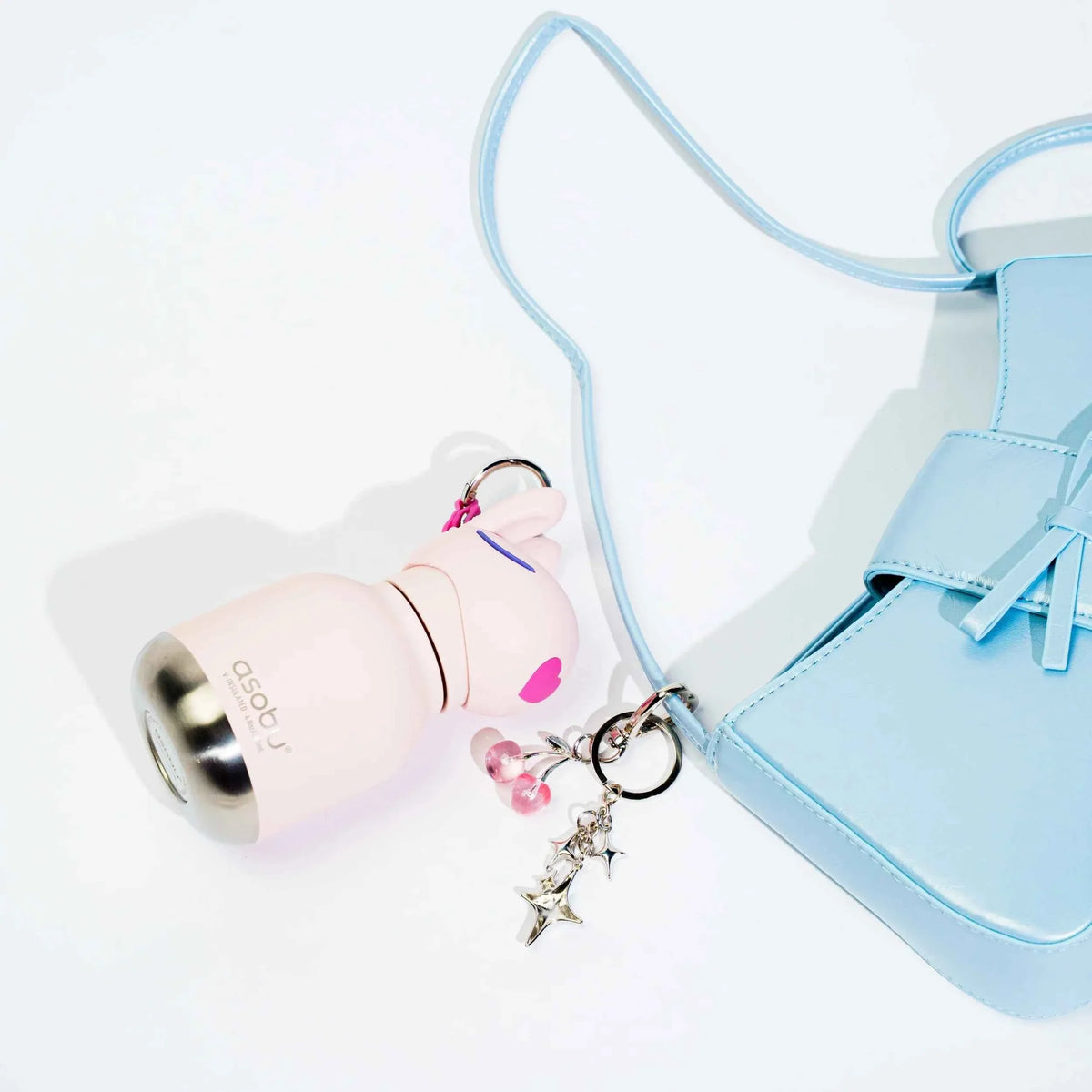 Beige mini animal water bottle keychain with star charm and light blue strap.