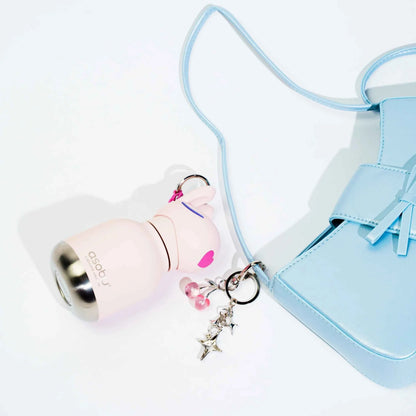 Beige mini animal water bottle keychain with star charm and light blue strap.