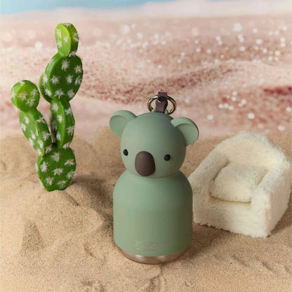 Koala-shaped mini water bottle on sand with mint body and metal key ring.