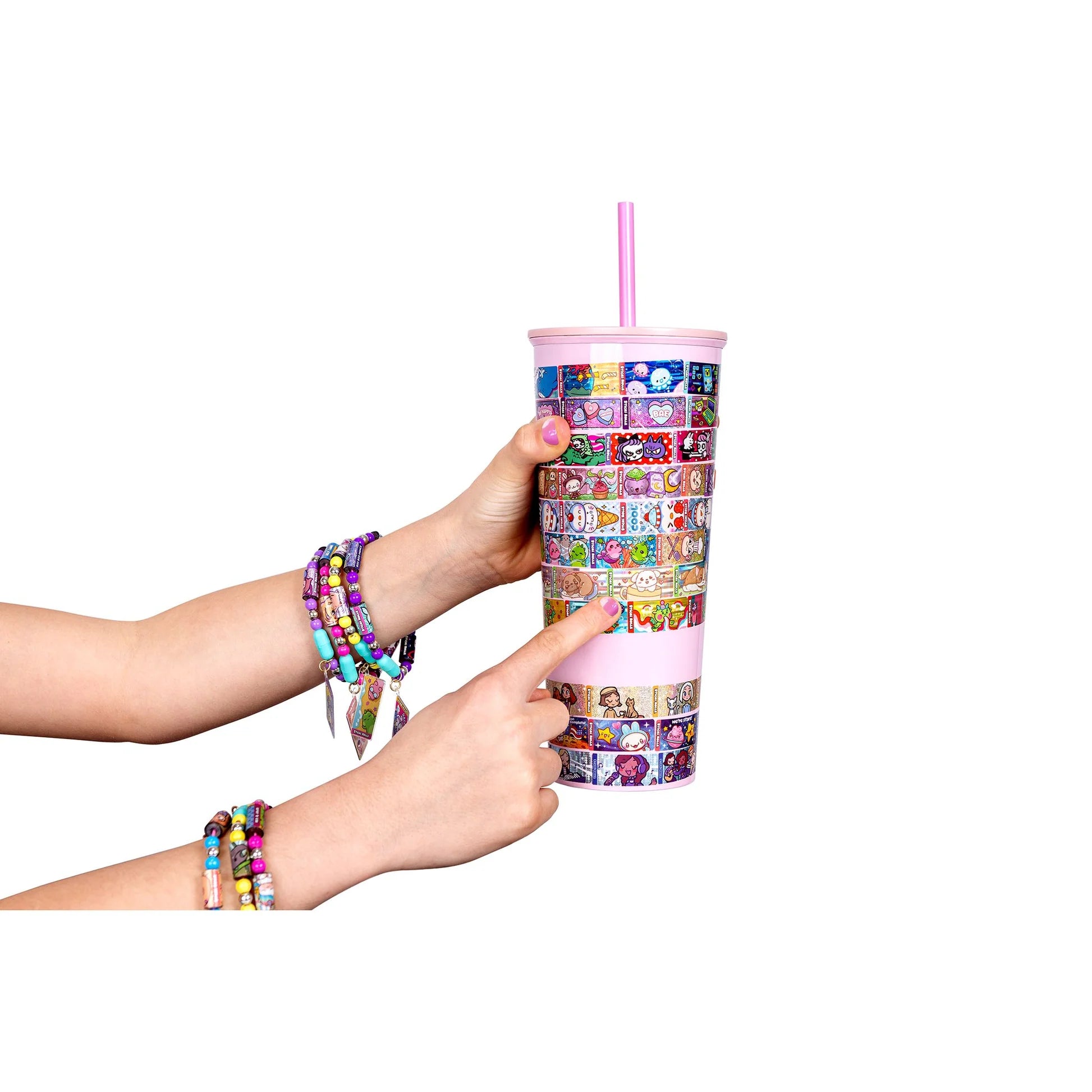Decorated sticker cup held in hands with colorful Sticki Rolls sticker designs