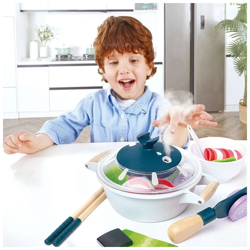Hotpot cooking playset being used, with pot and lid and wooden utensils