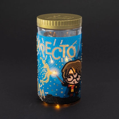 Blue decorative LED lamp in clear cylinder with gold lid and cat wizard design