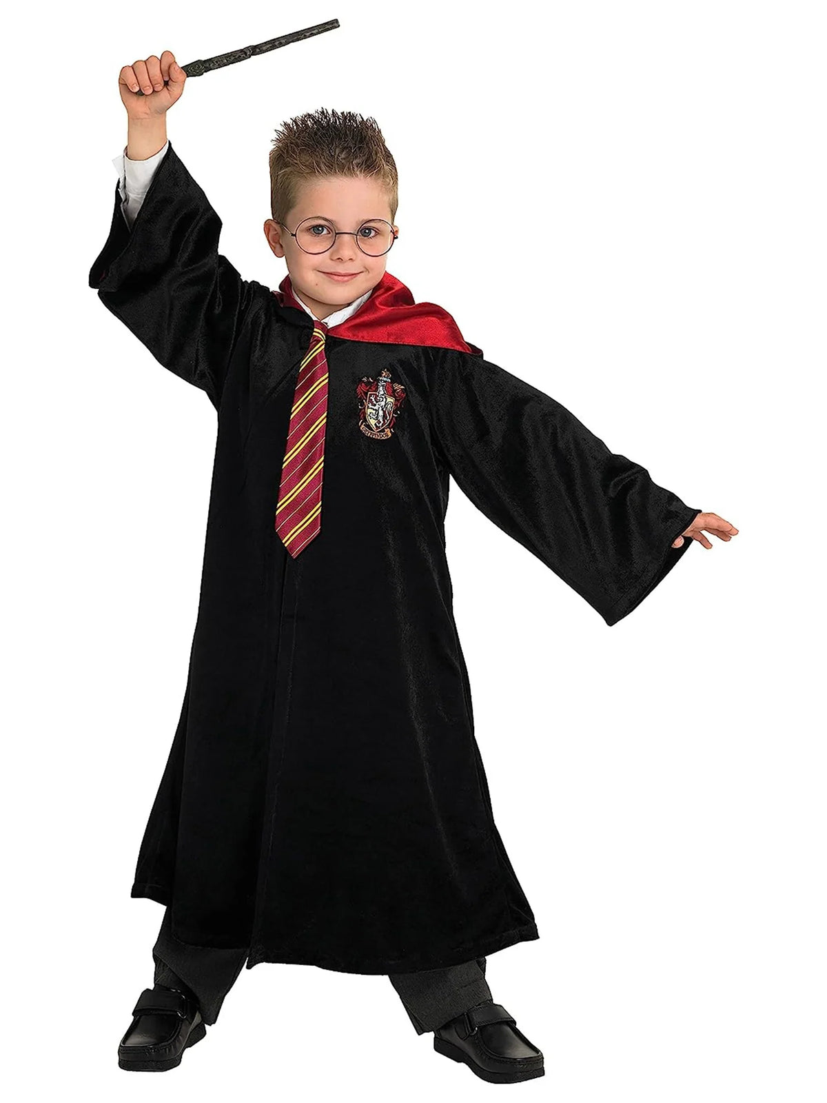 Child in black robe with red-and-gold striped tie, holding a wand