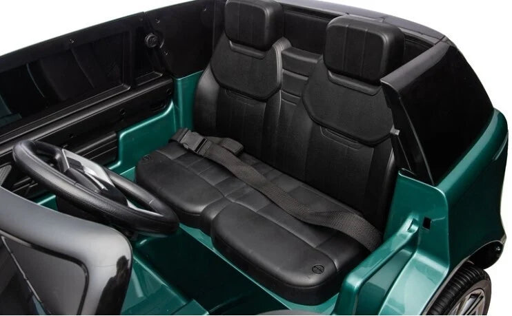 Teal ride-on SUV interior with black seats and dashboard, steering wheel visible