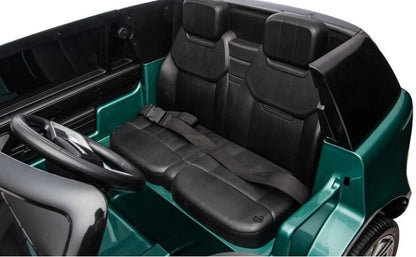 Teal ride-on SUV interior with black seats and dashboard, steering wheel visible