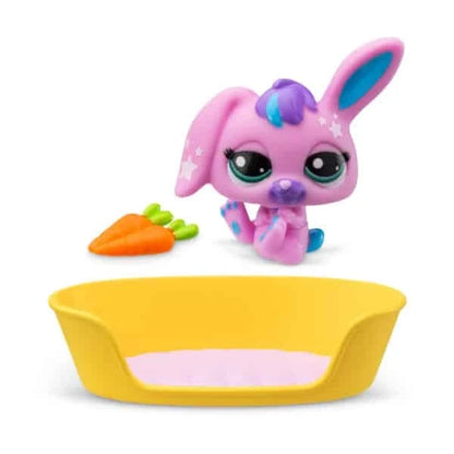 Pink bunny toy beside carrot accessory next to yellow pet bowl