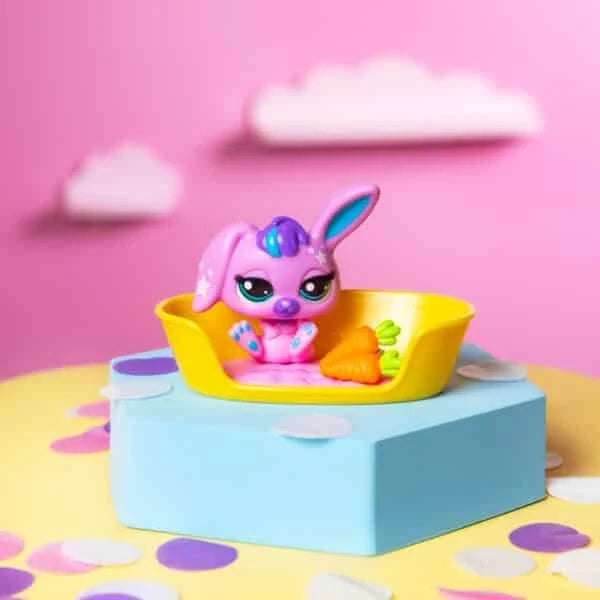 Purple bunny toy sitting in yellow pet bowl on blue base with carrot accessory
