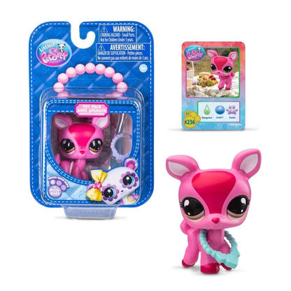 Pink pet surprise toy figure with big black eyes, shown in retail blister package