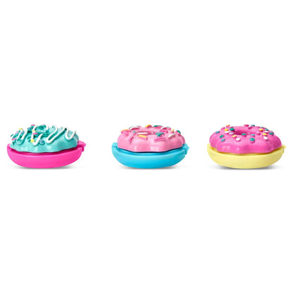 Donut-shaped lip balms in pink, blue, and yellow with sprinkle tops, closed containers