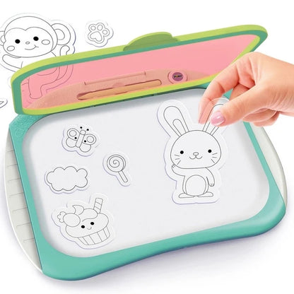 Children's doodle copy drawing pad with bunny outline and pink stylus, held by hand
