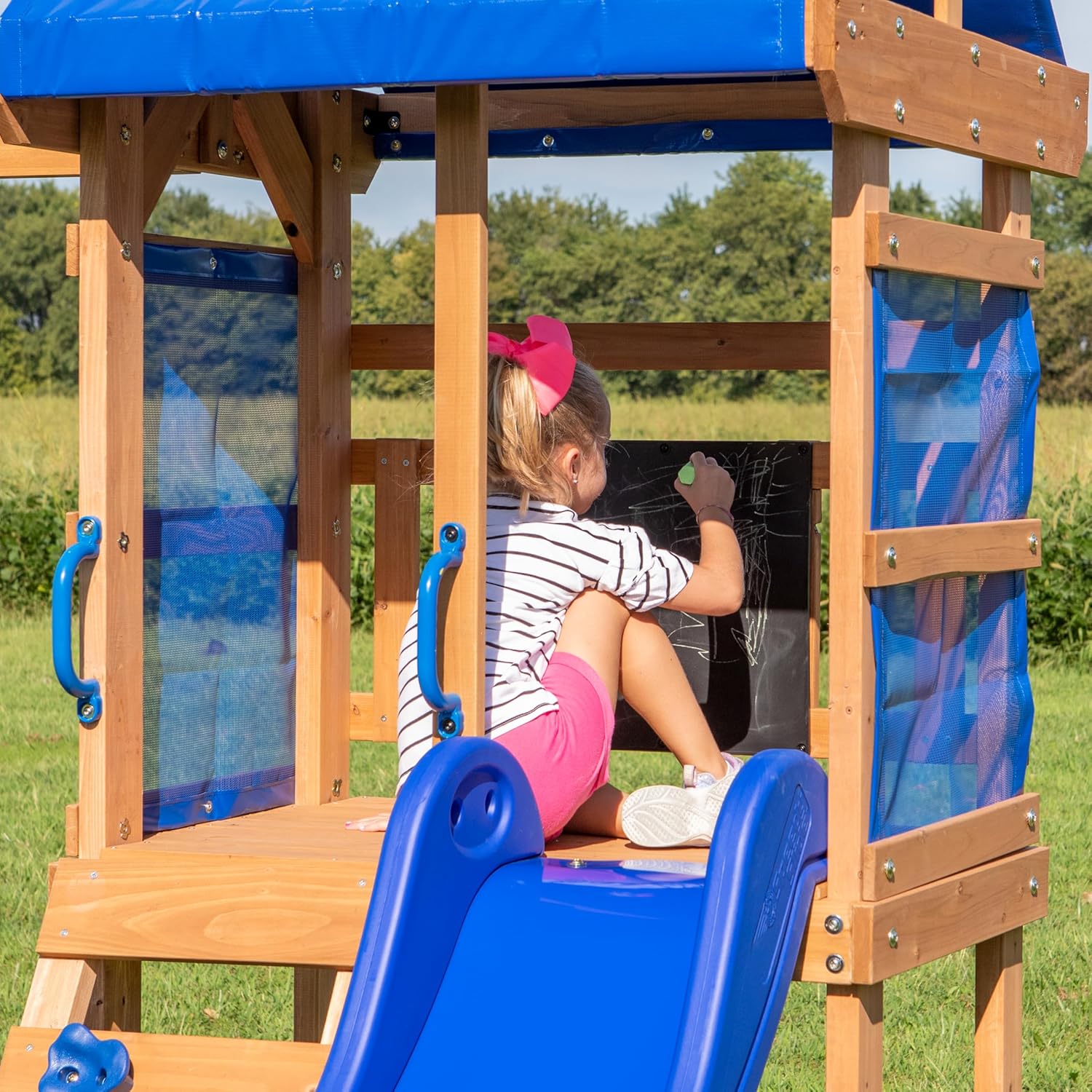 Cedar fort playhouse with mesh panels, blue handholds and blue floor