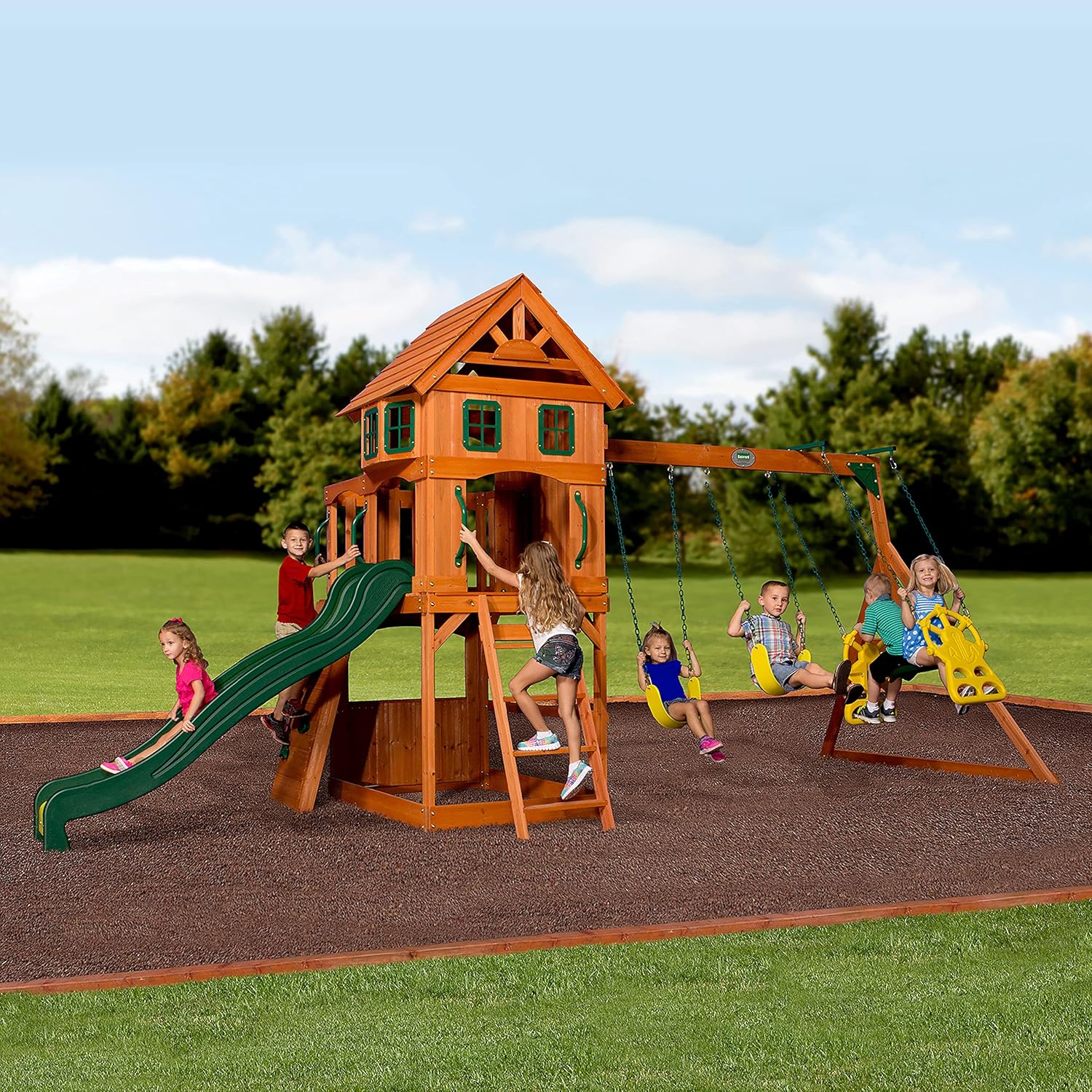 Wood playhouse swing set with green slide and multiple hanging swings