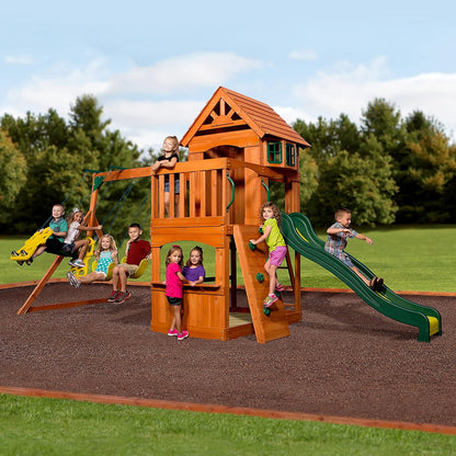 Wood playhouse swing set with green slide, platform swings and stairs