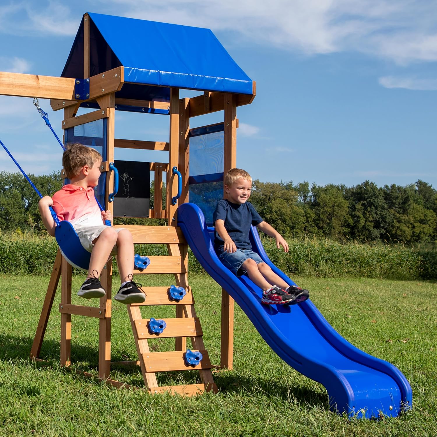 Cedar play centre with blue slide and step ladder, blue canopy over fort