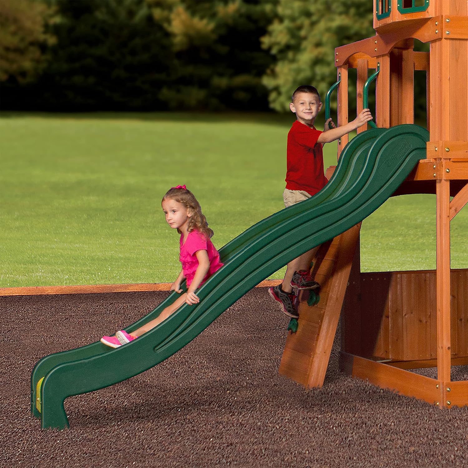 Green curved slide attached to the wood playhouse swing set