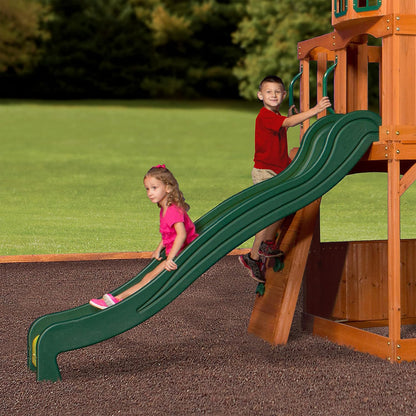 Green curved slide attached to the wood playhouse swing set