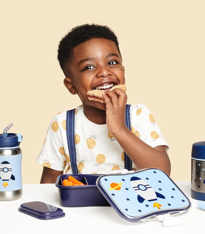 Skip Hop Zoo lunch kit on table, blue rocket-and-star design with open compartments