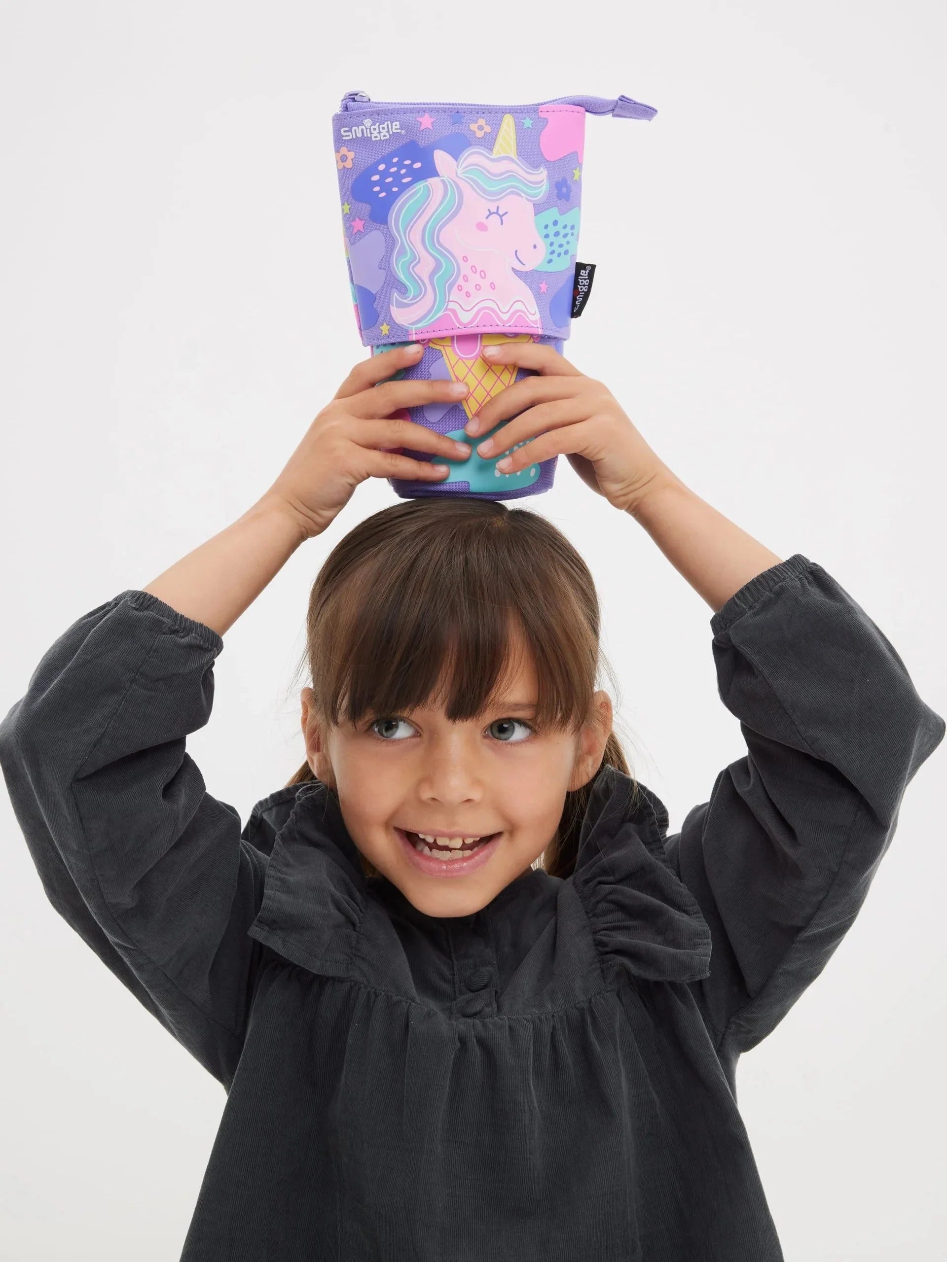 Smiggle pencil case with unicorn ice-cream print, held by hands, zip pouch