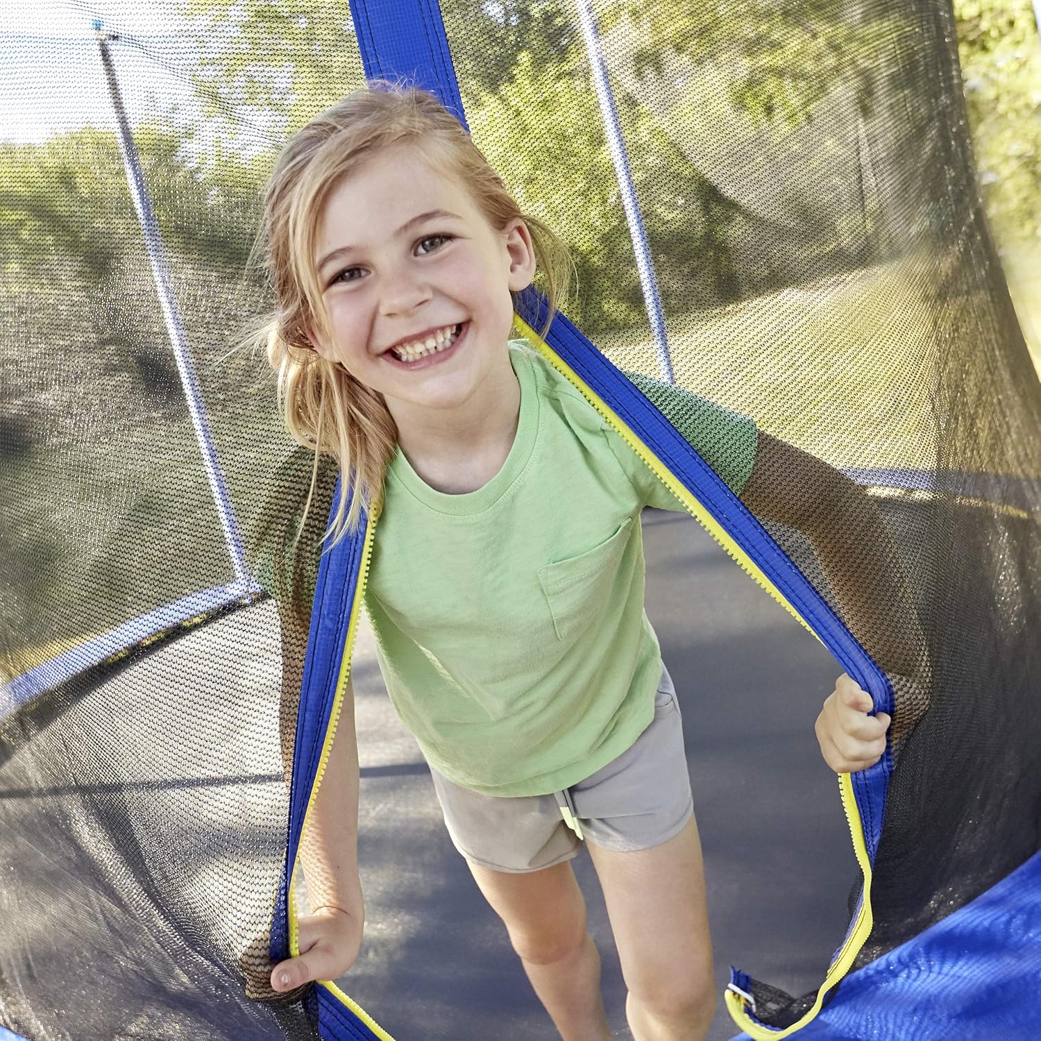 Trampoline safety net opening with blue frame and yellow trim, zipper edge