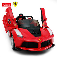 Kids ride-on sports car in red with black interior, open scissor-style doors