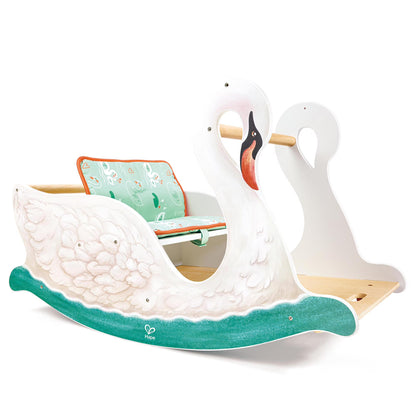 Rocking swan cradle with teal wave base, wooden runners, and patterned aqua cushion