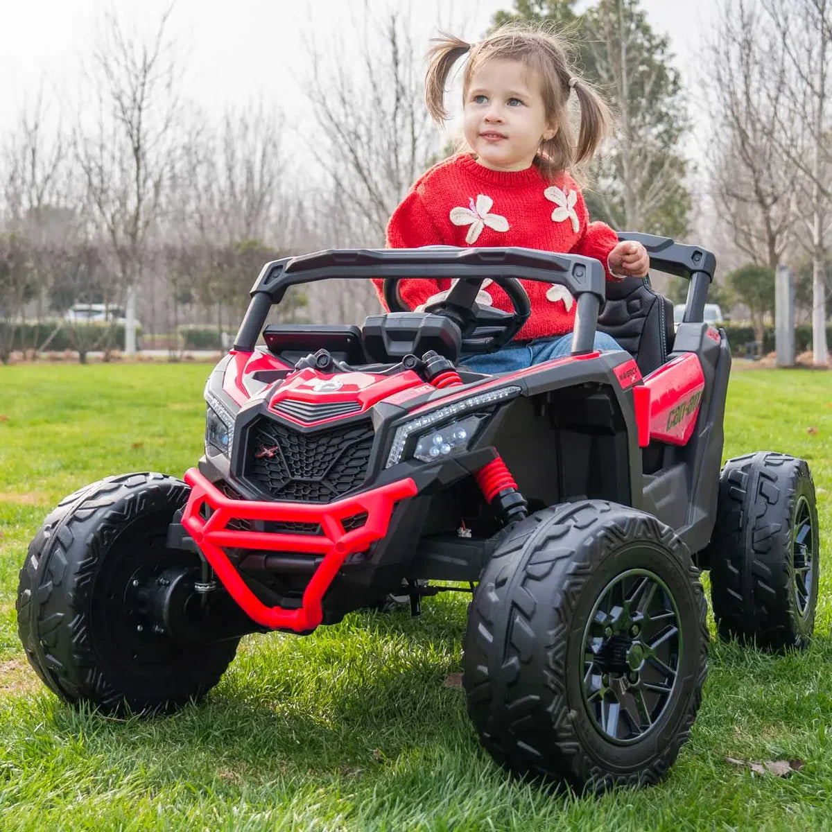 Red and black ride-on UTV with open cab, roll cage, and child driver