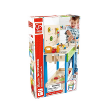 Toy workbench set in colorful retail box with child and wooden activity bench