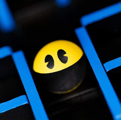 Pac-Man character tile with yellow face on a dark board with blue paths