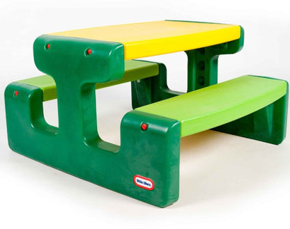 Children's picnic table with green supports and yellow top, two low bench seats