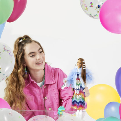 Blue tulle doll with rainbow skirt, held with green crocodile figure and pink lollipop