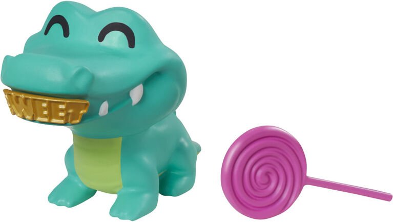 Green crocodile figure toy with gold mouth detail and pink spiral lollipop accessory