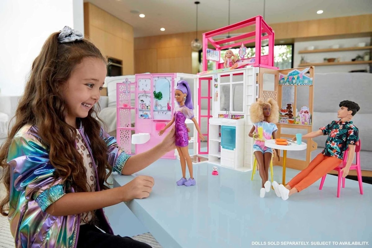 Dollhouse playset with pink-and-white doors, bed and kitchen area; dolls with puppy