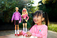 Fashion dolls with roller skates outdoors: purple hoodie doll and striped shirt doll
