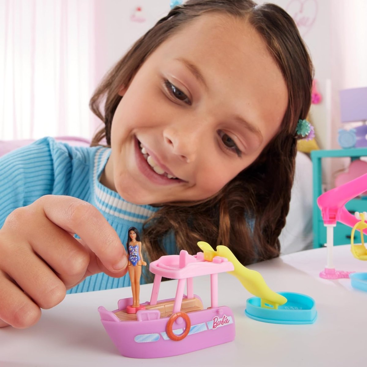 Mini Land toy vehicle set on table with small doll figure and slide pieces