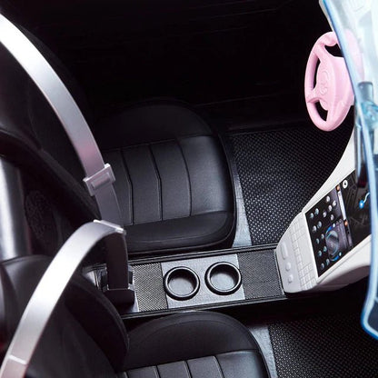 Convertible toy car interior with black seats, textured floor mat, and dual cupholders