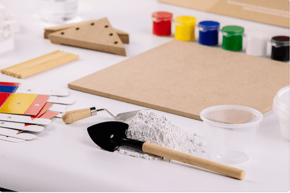 Construction craft tools with paint pots, wooden slats, and a trowel