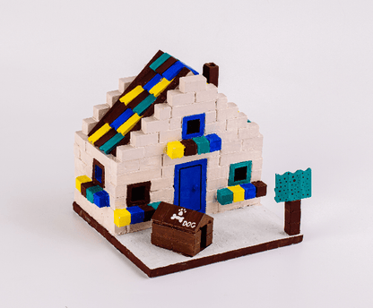 Brick dog house model with white walls, blue door, colorful details, and yard base