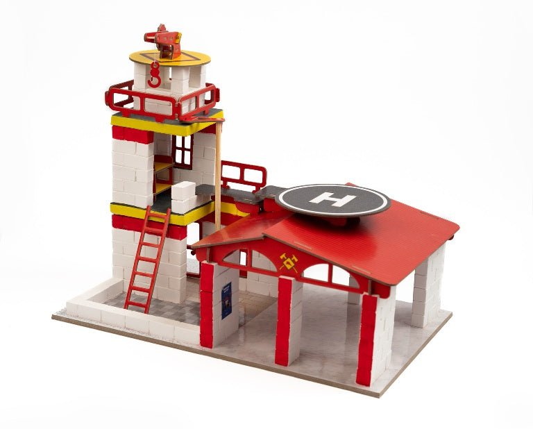 Fire Department playset building with ladder, red rails, and helipad sign on roof