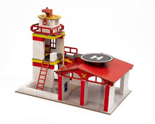 Fire Department playset building with ladder, red rails, and helipad sign on roof