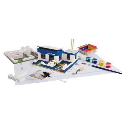 Police station building model with blue roof and POLICE STATION sign.