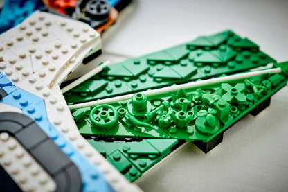 Close-up of white, blue, and green LEGO wing bricks and studs on the model