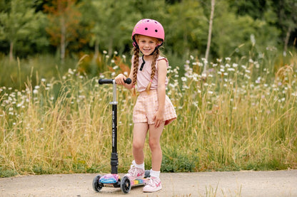 Kids' 3-wheel scooter with rainbow deck; child in pink helmet rides.