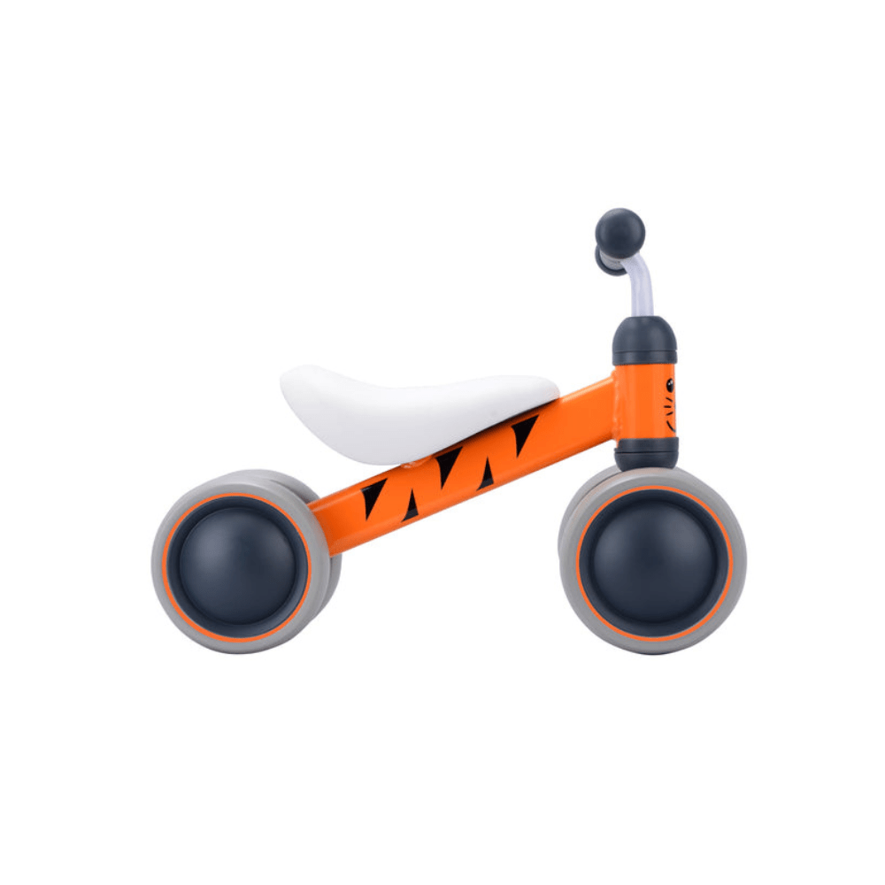 Orange tiger baby balance bike with white seat, black grips, and gray wheels