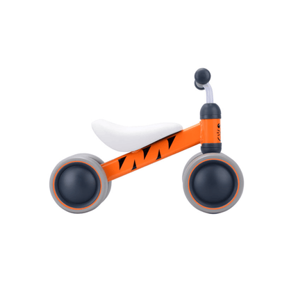 Orange tiger baby balance bike with white seat, black grips, and gray wheels