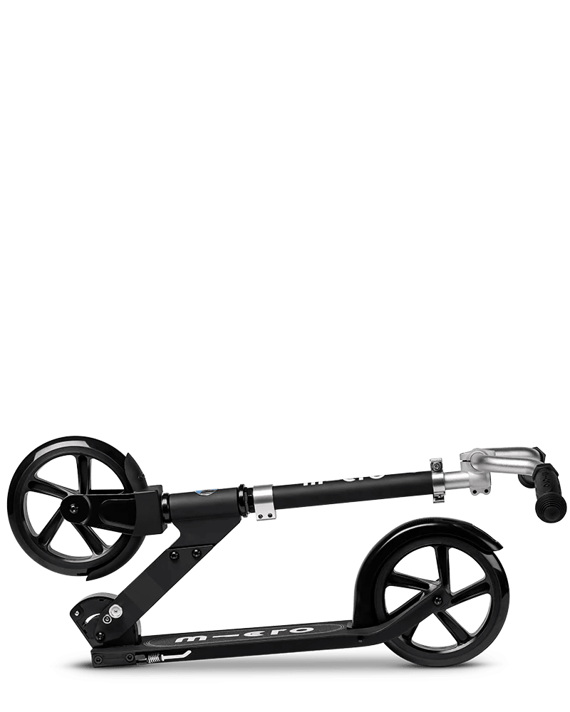 Micro Cruiser Black kick scooter side view with deck, wheels, and grips