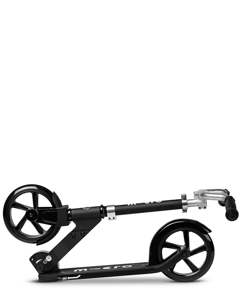 Black folding kick scooter with black wheels, black deck, and silver handlebars