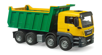 Yellow MAN TGS tipper truck with green dump bed, side view, wheels visible