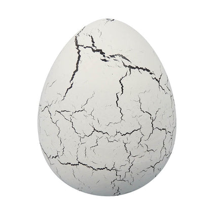 Cracked white dinosaur egg collectible toy with black crack lines
